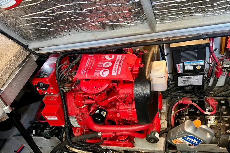 Slide: The Image of Engine compartment of a 1997 Sea Ray 370 Aft Cabin with visible fire extinguisher and battery charger. - 74