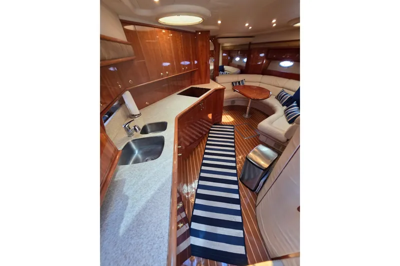 Slide: The Image of Luxurious interior of 2000 Neptunus 56 Express yacht with modern kitchen and seating area. - 11