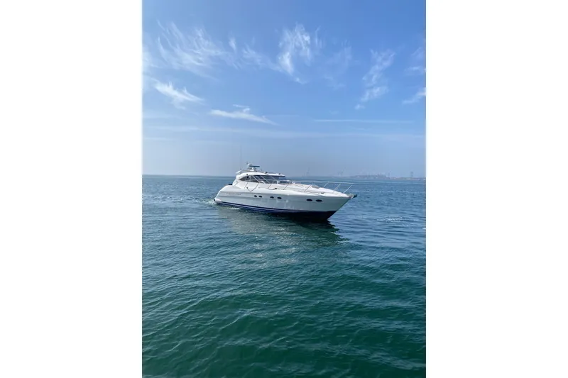 Slide: The Image of 2000 Neptunus 56 Express yacht cruising on calm blue waters under a clear sky. - 13