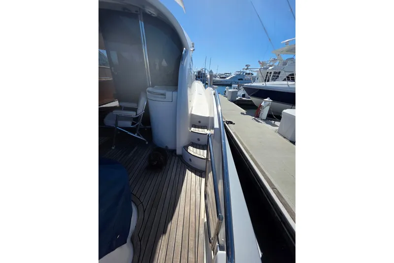 Slide: The Image of Side view of a 2000 Neptunus 56 Express yacht docked at a marina. - 14