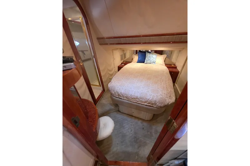 Slide: The Image of Cozy bedroom interior of 2000 Neptunus 56 Express yacht with elegant bedding and wood accents. - 19
