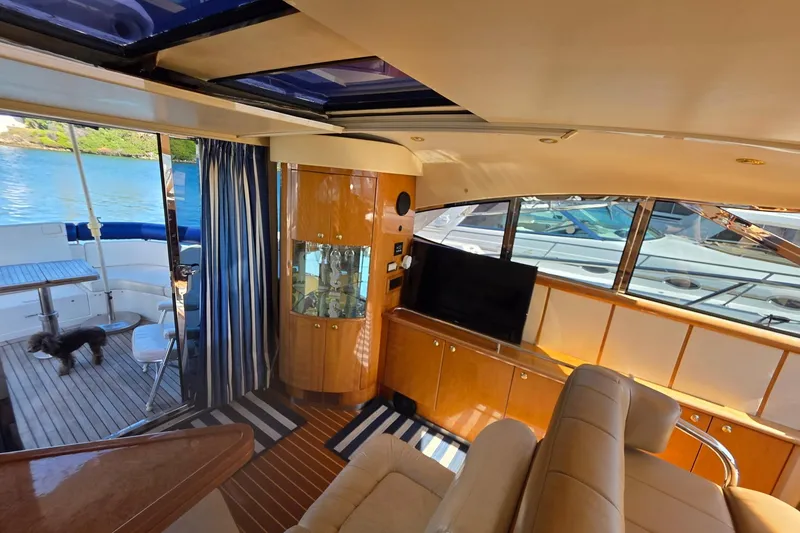 Slide: The Image of Luxurious interior of 2000 Neptunus 56 Express yacht with elegant wood finishes and scenic views. - 20