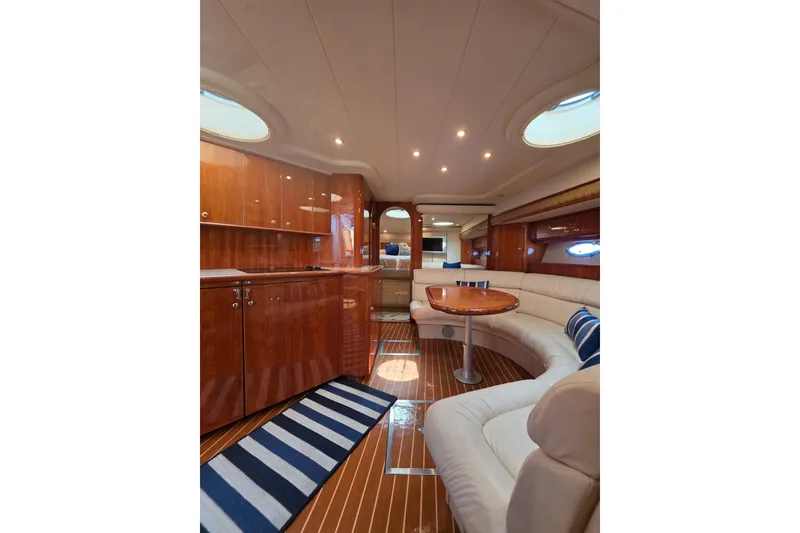 Slide: The Image of Luxurious interior of 2000 Neptunus 56 Express yacht with elegant wood finishes and plush seating. - 25