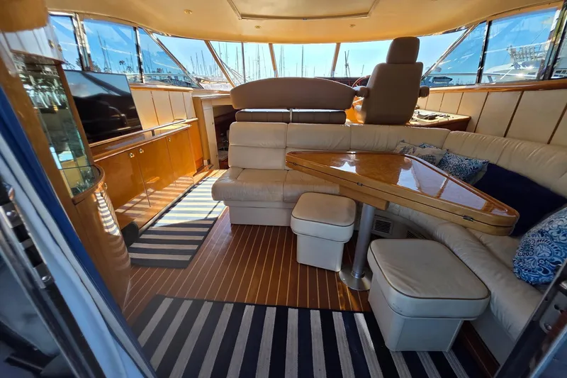 Slide: The Image of Luxurious interior of a 2000 Neptunus 56 Express yacht with elegant seating and wooden finishes. - 27
