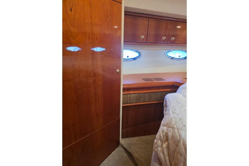 Slide: The Image of Interior of 2000 Neptunus 56 Express yacht with wood cabinetry and porthole windows. - 32