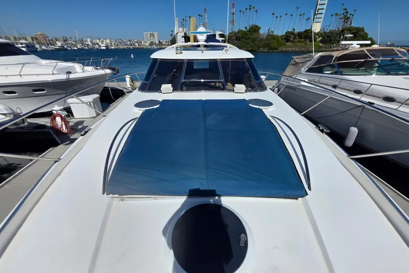 Slide: The Image of 2000 Neptunus 56 Express yacht docked at marina with blue cover. - 9