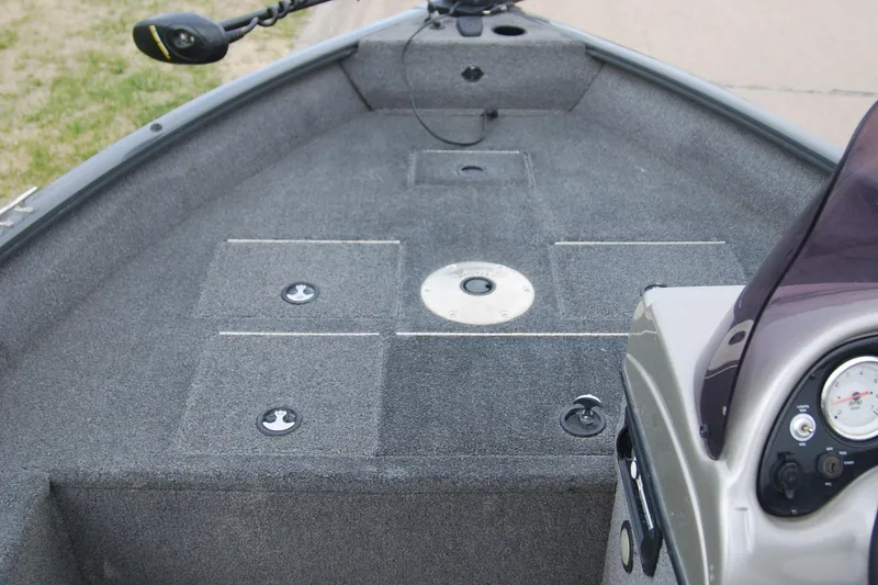 Slide: The Image of 2015 Tracker Pro Guide V-16 SC boat interior with carpeted deck and control panel. - 4