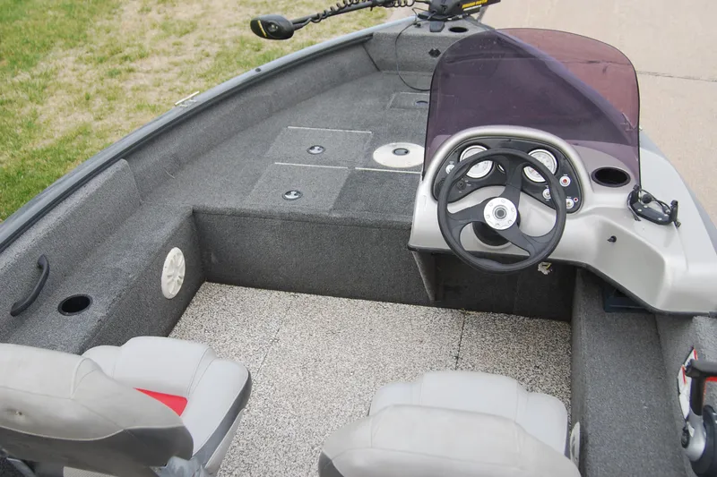 Slide: The Image of 2015 Tracker Pro Guide V-16 SC boat interior with steering console and seating. - 5