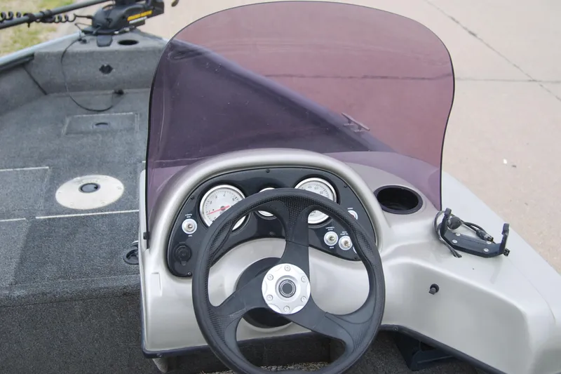 Slide: The Image of 2015 Tracker Pro Guide V-16 SC boat dashboard with steering wheel and gauges. - 6