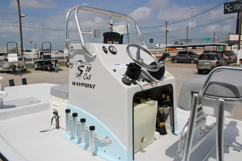 Slide: The Image of 2023 Shoalwater 19' Catamaran boat console with steering wheel and controls. - 3