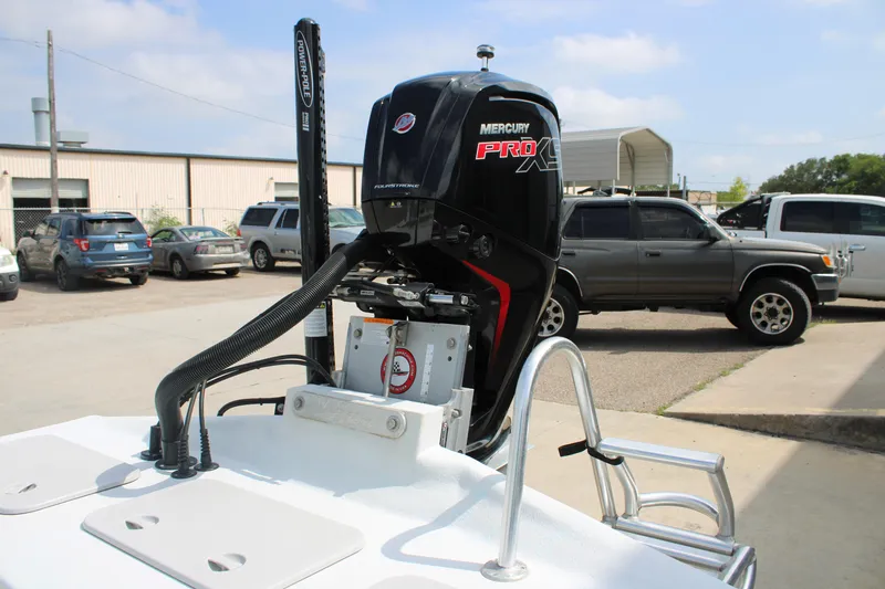 Slide: The Image of 2023 Shoalwater 19' Catamaran with Mercury Pro XS engine in a parking lot. - 4