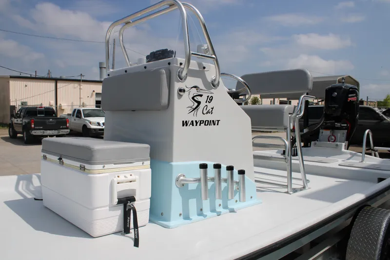 Slide: The Image of 2023 Shoalwater 19' Catamaran boat with seating and storage, parked outdoors. - 5
