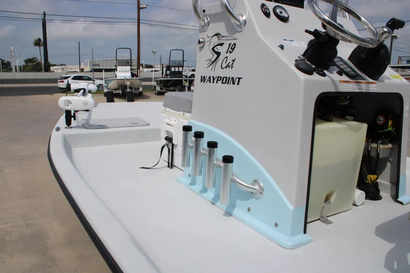 Slide: The Image of 2023 Shoalwater 19' Catamaran boat console with steering wheel and rod holders. - 6