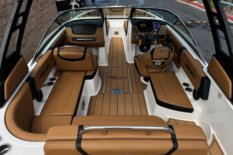 Slide: The Image of Luxurious interior of 2024 Chaparral 247 SSX boat with tan seating and modern dashboard. - 10