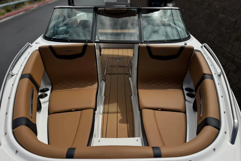 Slide: The Image of 2024 Chaparral 247 SSX boat interior with tan leather seating and sleek design. - 11