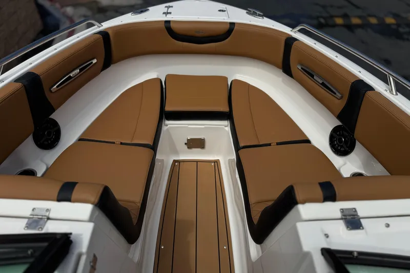 Slide: The Image of 2024 Chaparral 247 SSX boat interior with tan leather seating and sleek design. - 15
