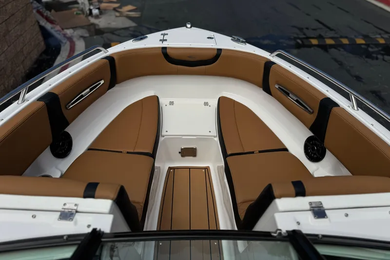 Slide: The Image of 2024 Chaparral 247 SSX boat interior with tan seating and sleek design. - 16