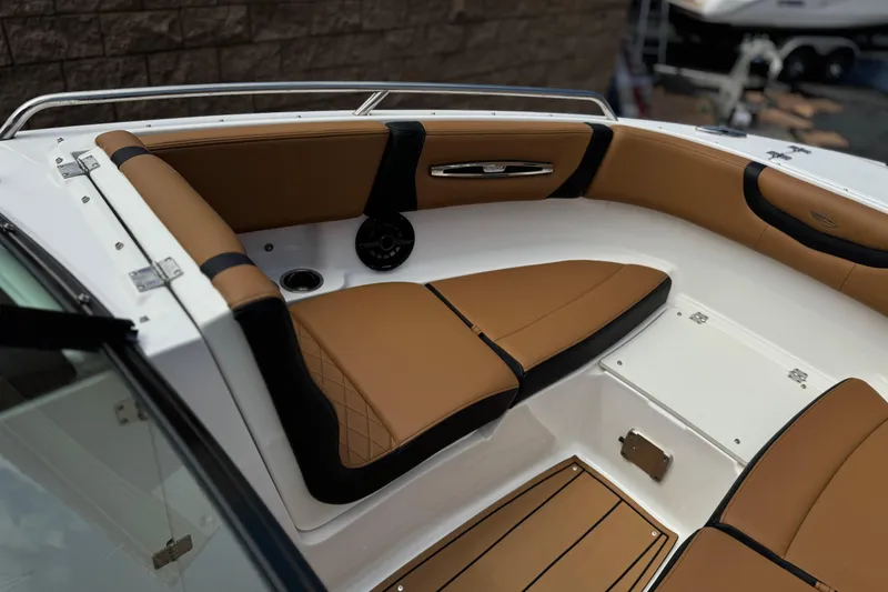Slide: The Image of 2024 Chaparral 247 SSX boat interior with tan and black seating, sleek design. - 17