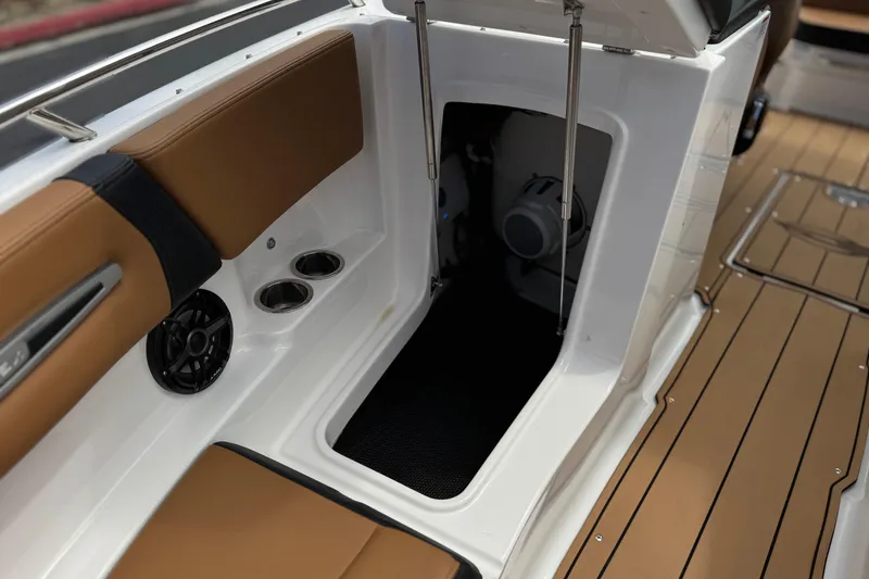 Slide: The Image of 2024 Chaparral 247 SSX boat interior with storage compartment and seating area. - 20