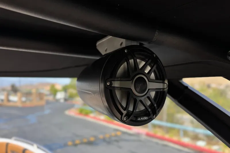 Slide: The Image of JL Audio speaker on 2024 Chaparral 247 SSX boat, mounted under a black canopy. - 23