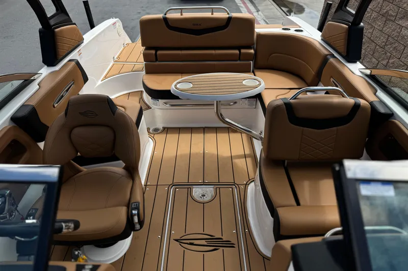 Slide: The Image of 2024 Chaparral 247 SSX boat interior with tan seating and sleek design. - 24