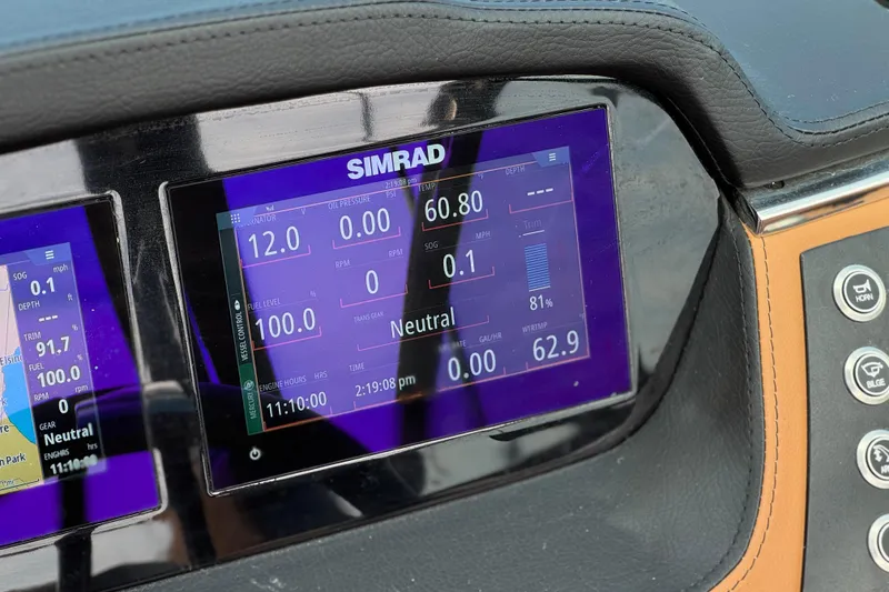 Slide: The Image of Simrad display on 2024 Chaparral 247 SSX boat dashboard showing navigation data. - 36
