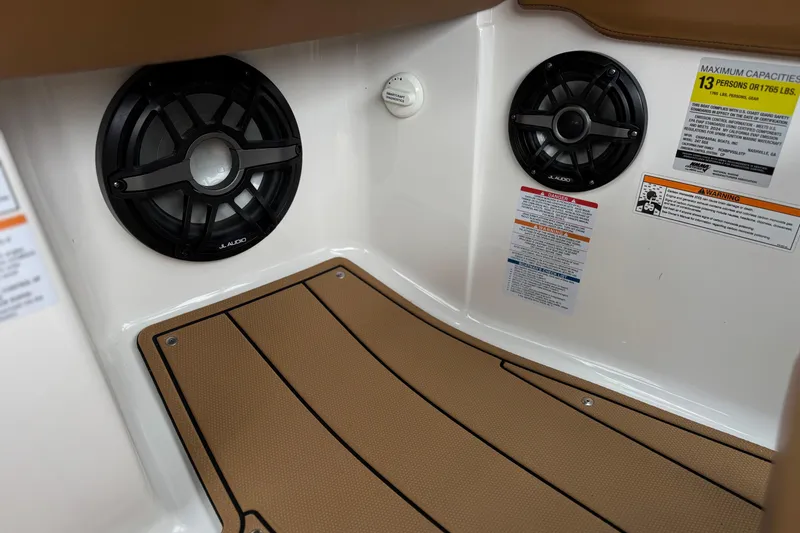 Slide: The Image of 2024 Chaparral 247 SSX interior with JL Audio speakers and safety labels. - 38