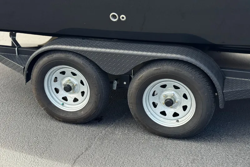 Slide: The Image of Trailer wheels of a 2024 Chaparral 247 SSX boat on a textured surface. - 39