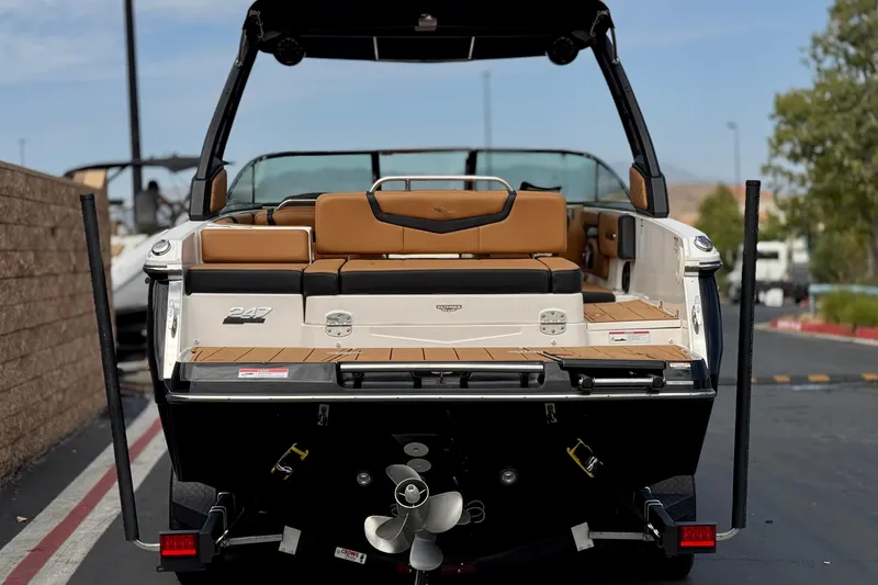 Slide: The Image of 2024 Chaparral 247 SSX boat rear view with tan seating and teak deck. - 4