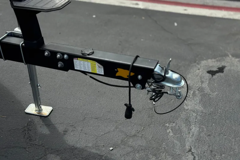 Slide: The Image of Trailer hitch of 2024 Chaparral 247 SSX on asphalt surface. - 40