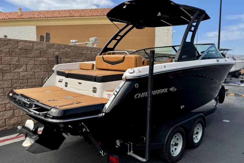 Slide: The Image of 2024 Chaparral 247 SSX boat on trailer, featuring sleek black design and tan seating. - 5