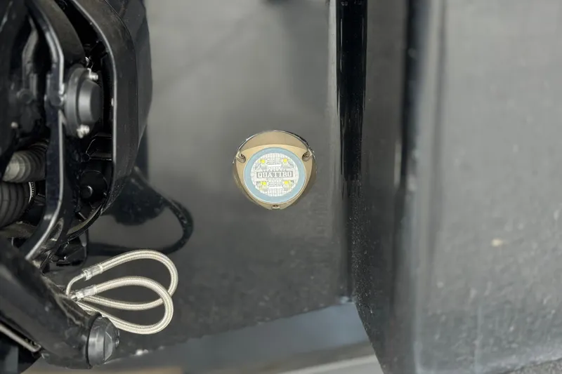 Slide: The Image of Close-up of 2024 Chaparral 247 SSX boat component with visible wiring and label. - 8
