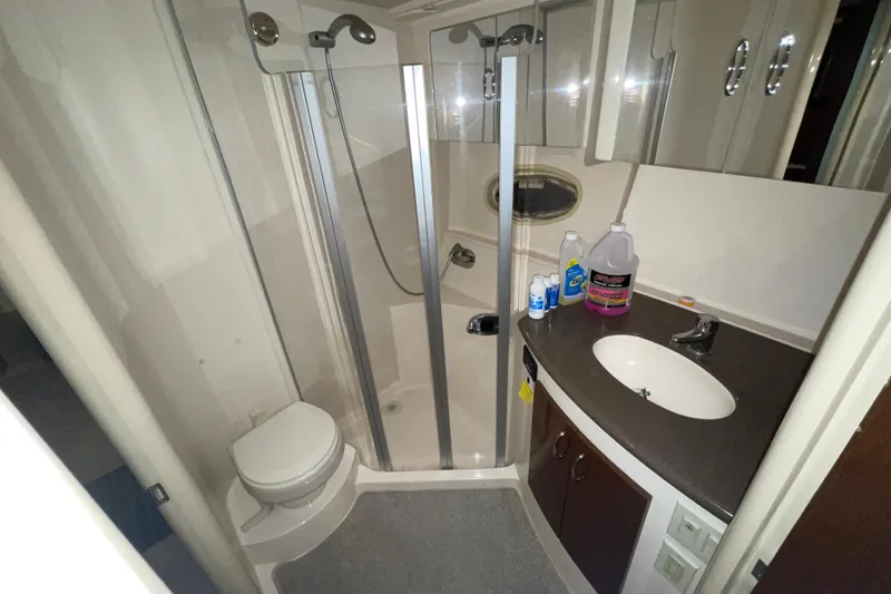 Slide: The Image of 2007 Carver 360 Mariner bathroom with shower, sink, and cleaning supplies. - 10
