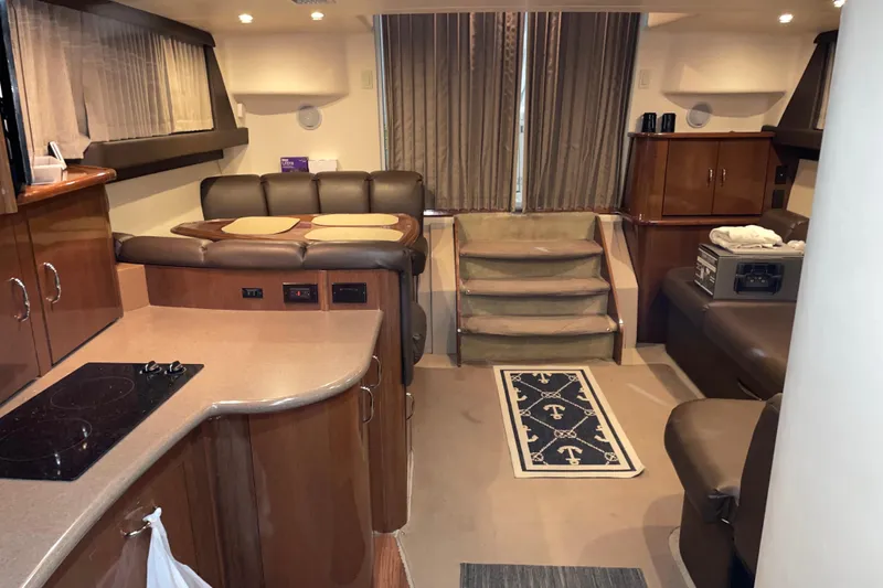 Slide: The Image of Interior of a 2007 Carver 360 Mariner yacht with modern furnishings and kitchen area. - 13