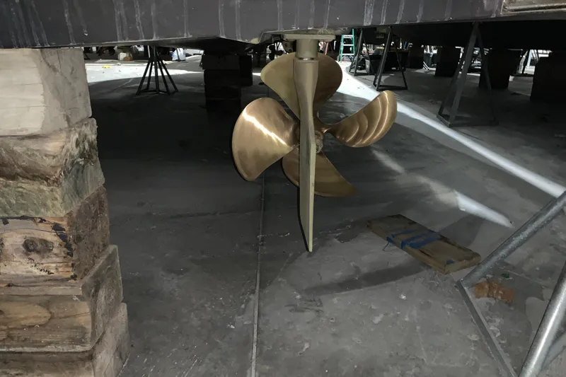 Slide: The Image of Propeller of a 2007 Carver 360 Mariner boat in a workshop setting. - 2