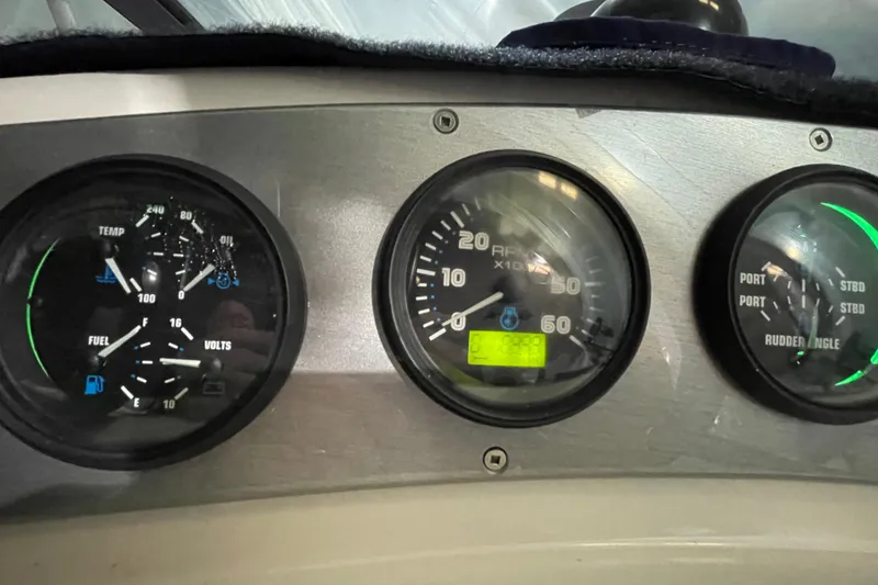Slide: The Image of Dashboard gauges of a 2007 Carver 360 Mariner boat, displaying RPM, fuel, and rudder angle. - 20