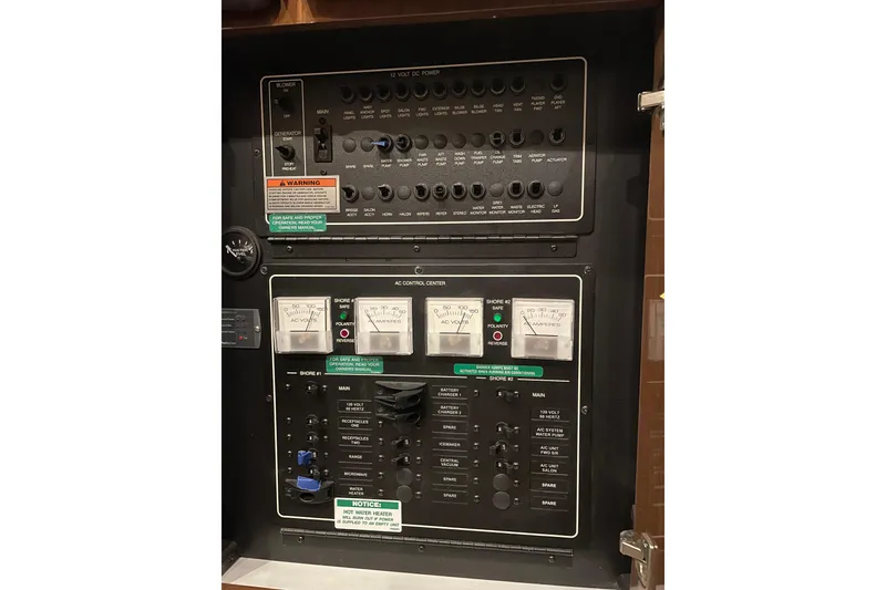 Slide: The Image of Electrical control panel of a 2007 Carver 360 Mariner boat, featuring various switches and meters. - 32