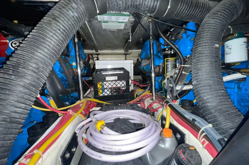 Slide: The Image of Engine room of a 2007 Carver 360 Mariner with visible hoses and wiring. - 39