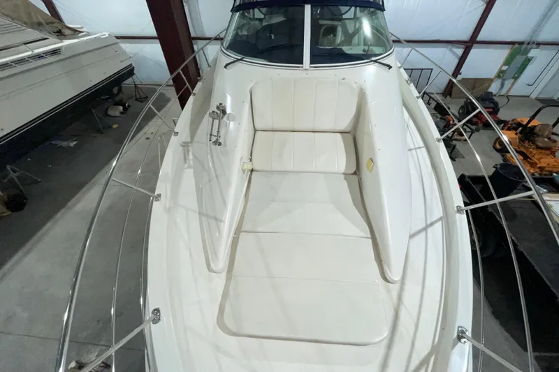 Slide: The Image of 2007 Carver 360 Mariner boat interior with white seating, docked indoors. - 46
