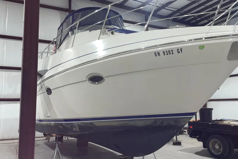 Slide: The Image of 2007 Carver 360 Mariner yacht in storage, showcasing sleek design and registration number OH 9302 GF. - 48