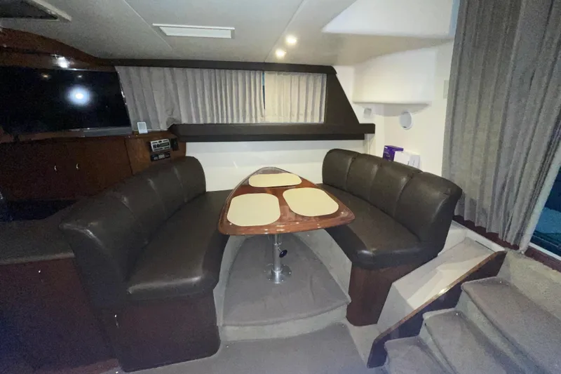 Slide: The Image of Interior of 2007 Carver 360 Mariner with dining area and leather seating. - 5