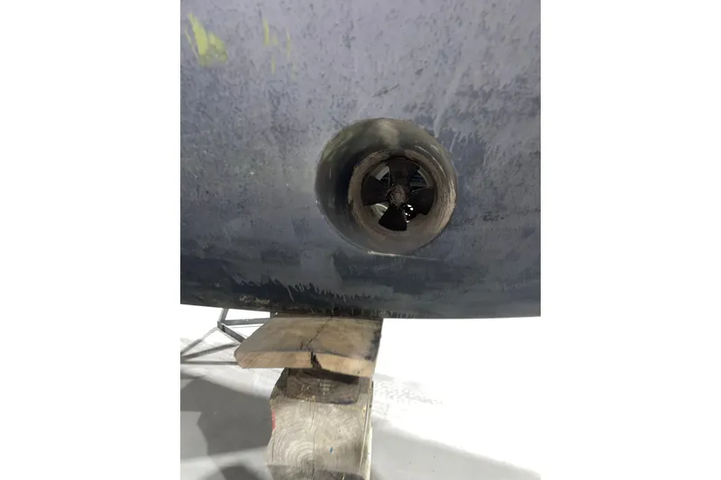 Slide: The Image of Close-up of a 2007 Carver 360 Mariner's propeller on a wooden stand. - 50