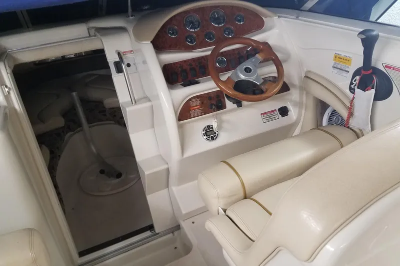 Slide: The Image of Interior of a 2001 Sea Ray 260 Overnighter boat, featuring helm and cabin entrance. - 5