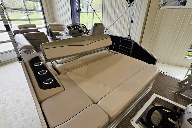 Slide: The Image of 2019 Bennington 21 SX Swingback pontoon boat interior with beige seating and cup holders. - 6