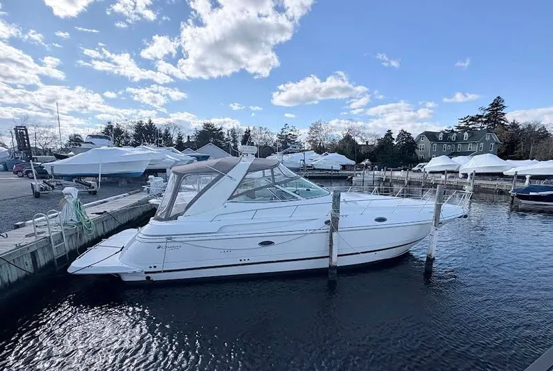 The Image of 2001 Cruisers Yachts 3870 docked at marina on a sunny day. - 0