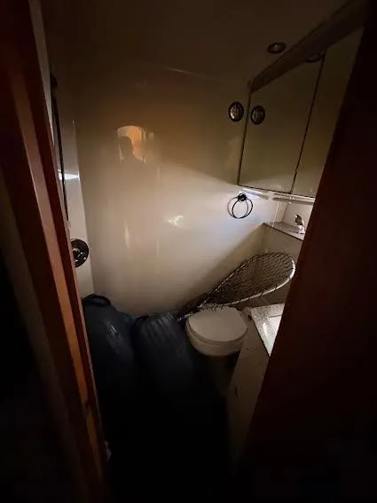 Slide: The Image of 2001 Cruisers Yachts 3870 bathroom with toilet and storage space. - 12
