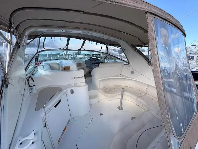 Slide: The Image of Interior of a 2001 Cruisers Yachts 3870 with seating area and helm. - 3