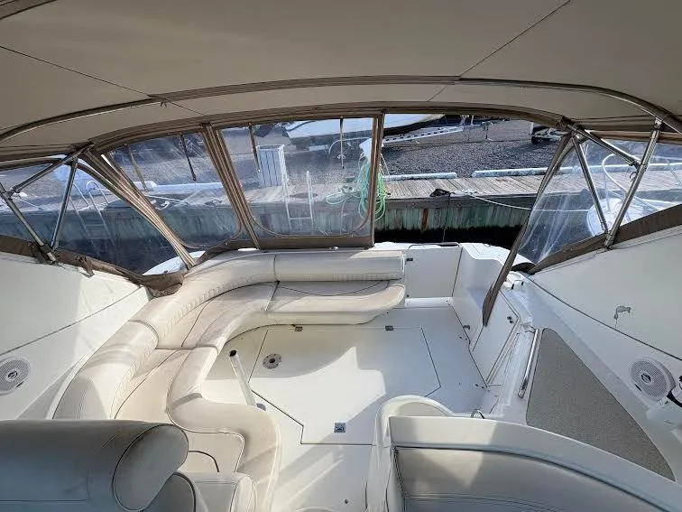 Slide: The Image of Interior of a 2001 Cruisers Yachts 3870 with beige seating area. - 4
