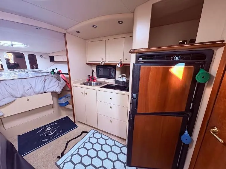 Slide: The Image of Interior of 2001 Cruisers Yachts 3870 with kitchen and sleeping area. - 7