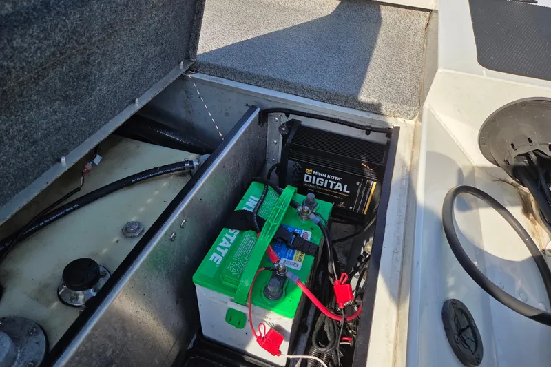 Slide: The Image of 2022 G3 Sportsman 1610 boat battery compartment with Minn Kota digital charger. - 10
